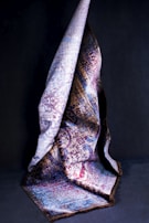 Close-up of a nubian-inspired panjabi fabric, rich in texture and earth tones, folded neatly.