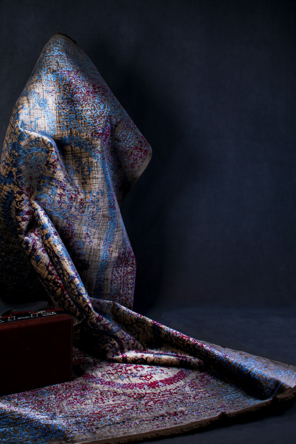 blue and red textile on brown wooden table