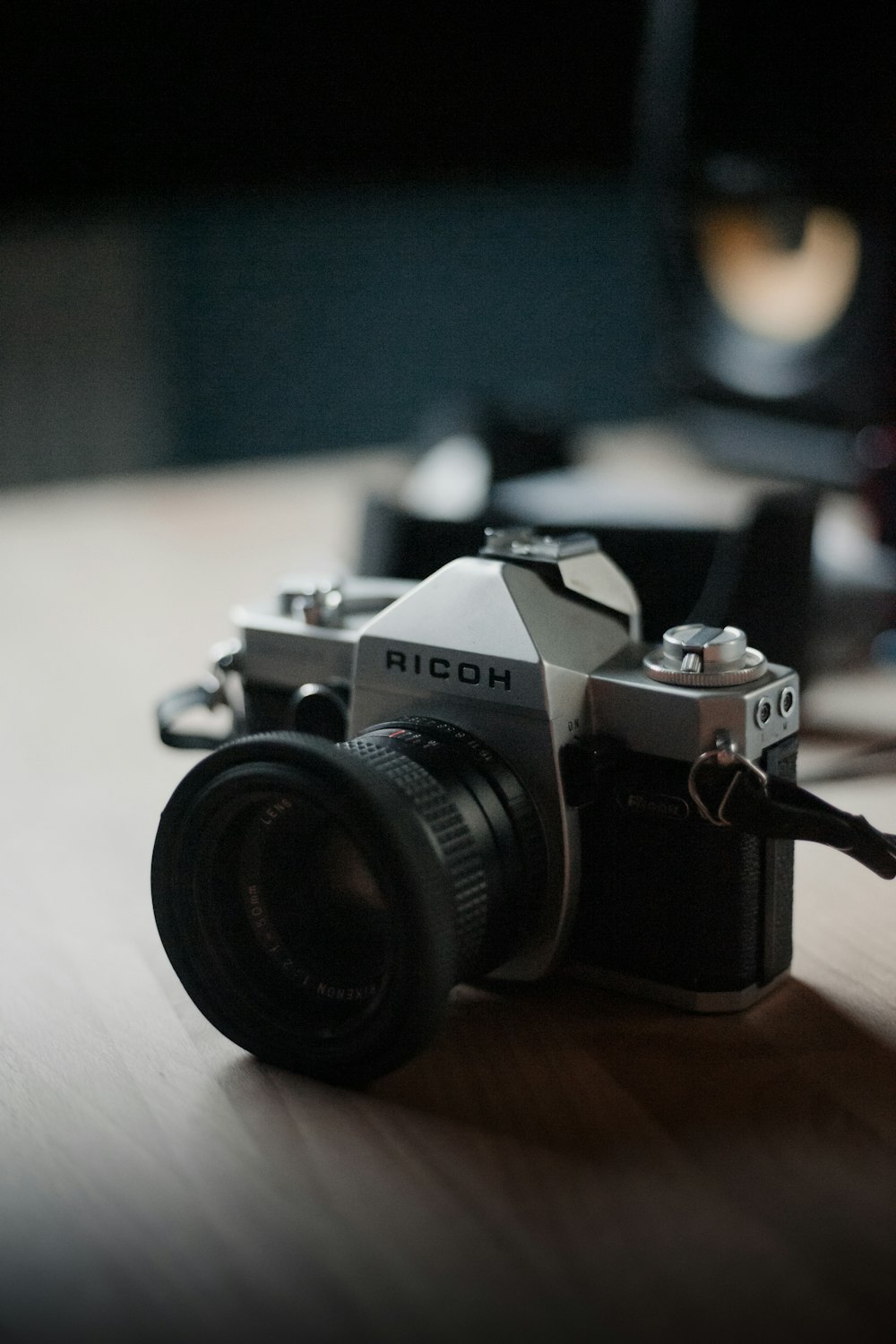 black and silver nikon dslr camera on brown wooden table