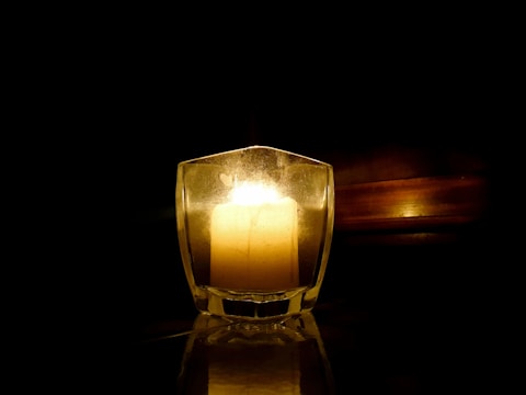 A candle showcasing a special message, surrounded by soft lighting.