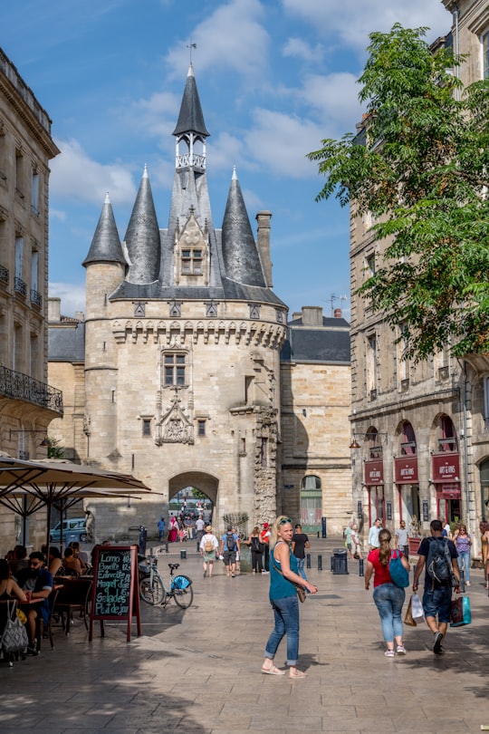 people walking on street near brown concrete building during daytime in Puerta de Cailhau France