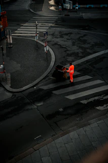 Early morning scene of a Binshufflers worker wheeling bins along a suburban street.
