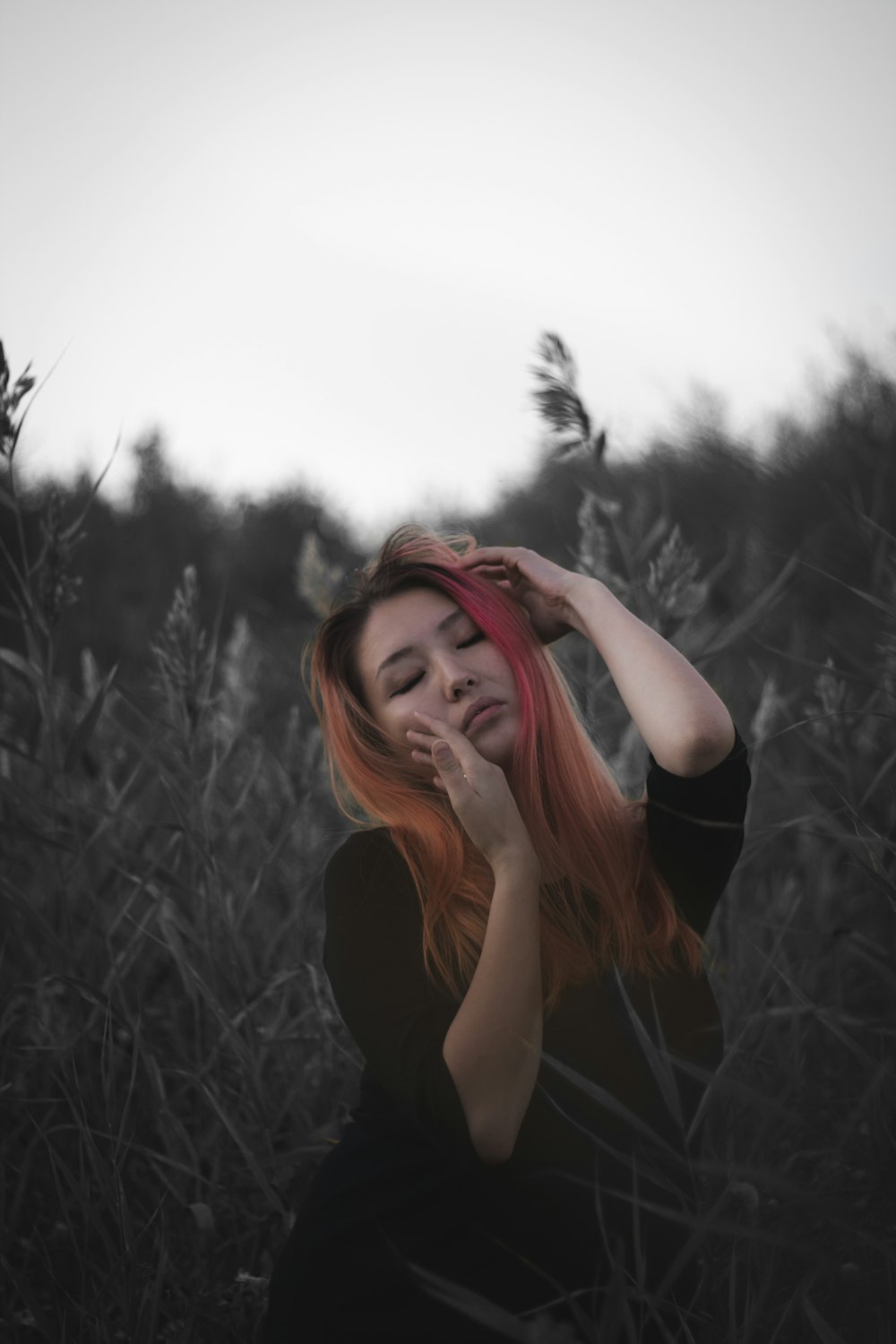 woman in black shirt standing on grass field