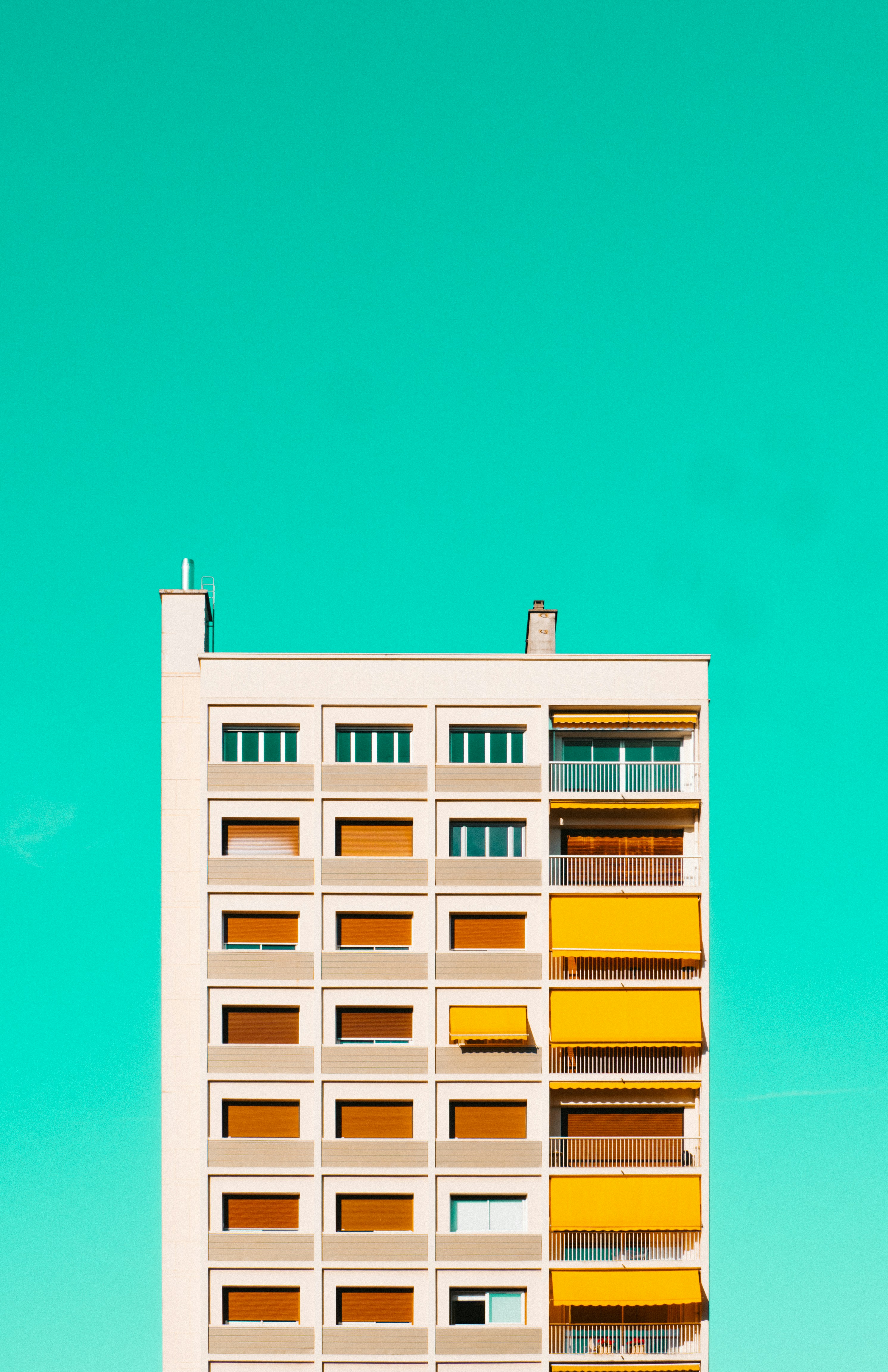 white and yellow concrete building under blue sky during daytime