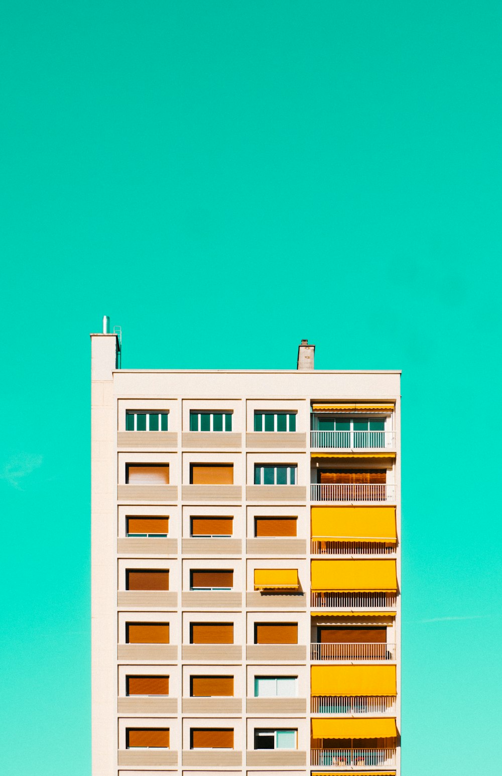 white and yellow concrete building under blue sky during daytime