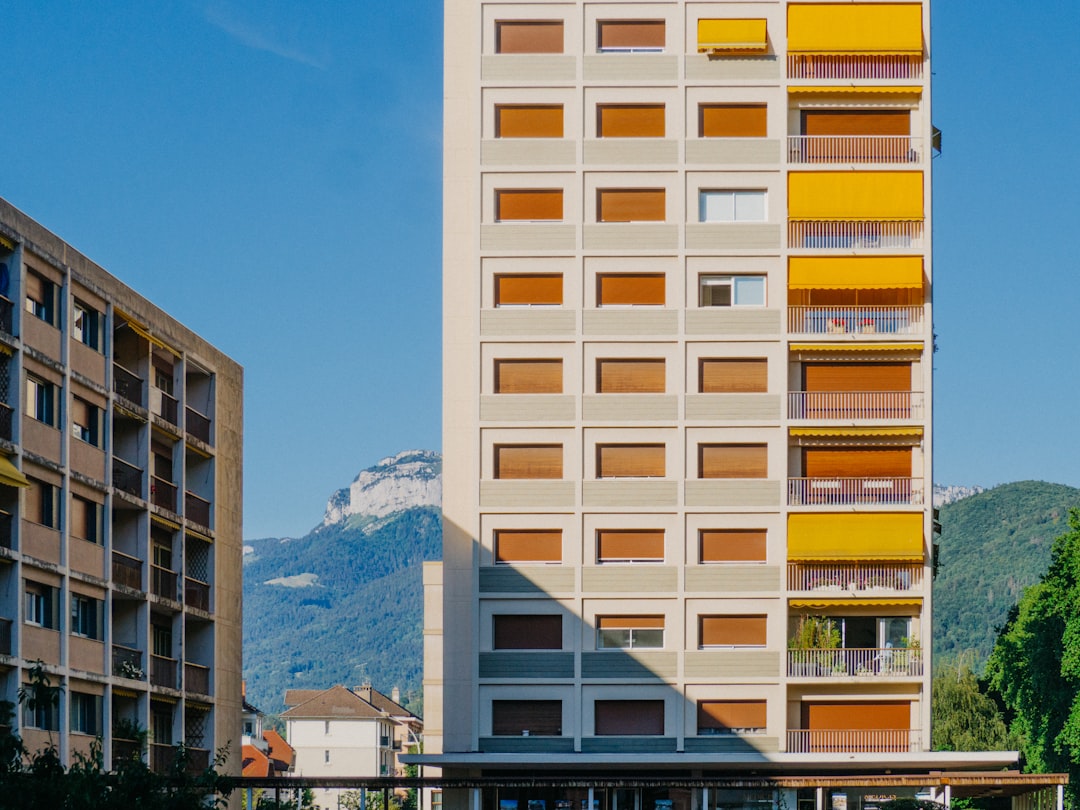 brown concrete building near mountain under blue sky during daytime