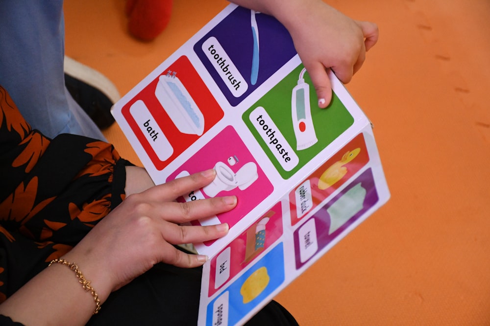 person holding white and pink heart print board