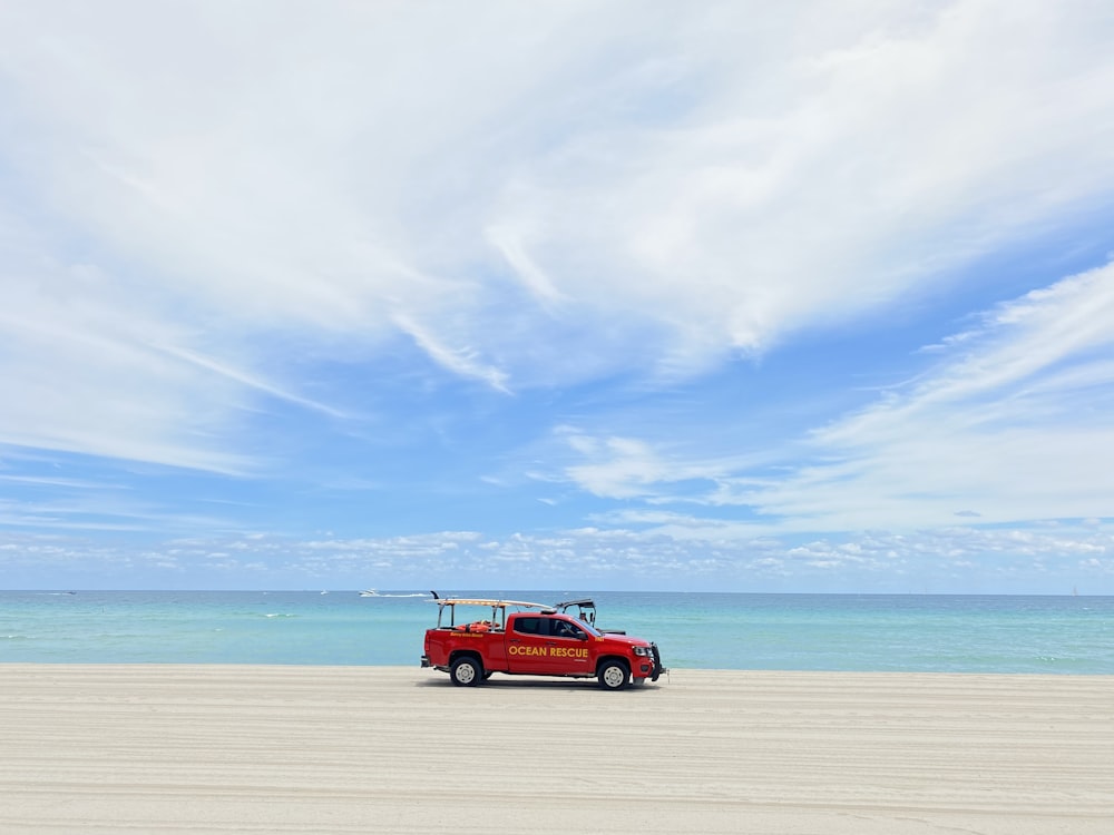 red suv on beach during daytime