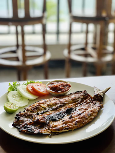 A grilled whole fish plated at a seafood restaurant