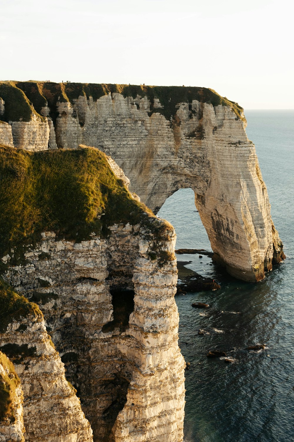 brown rock formation on sea during daytime