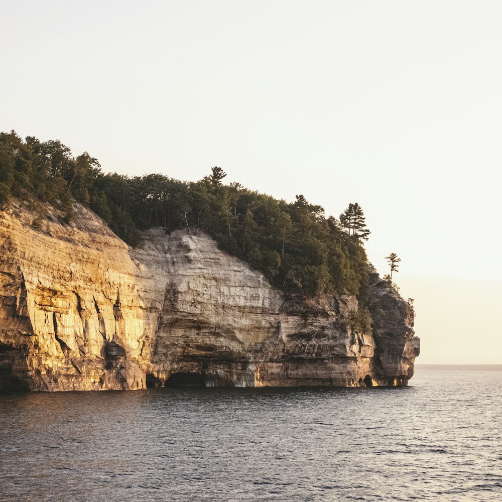 brown rock formation on sea during daytime