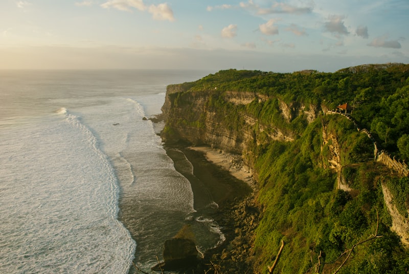 The Uluwatu cliffs at golden hour with surf below