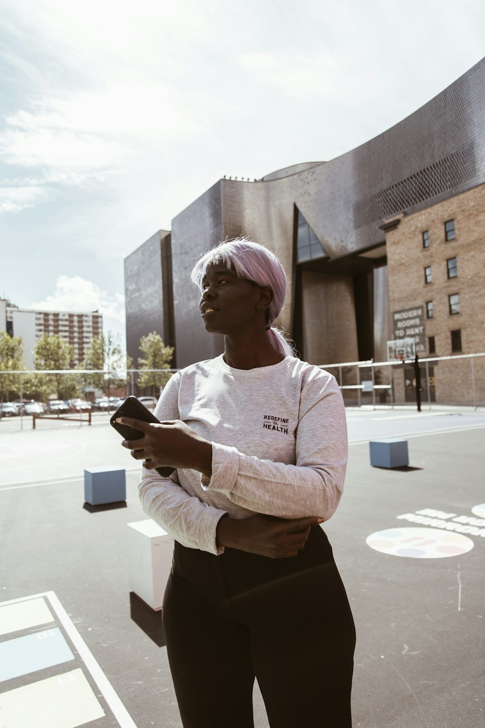 woman in white long sleeve shirt holding smartphone