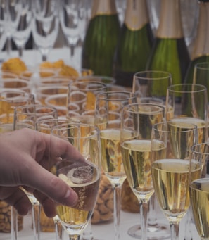 person holding clear drinking glass