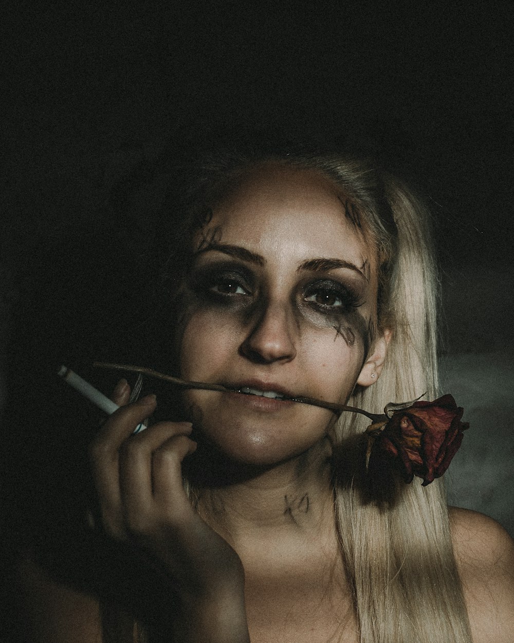 woman with red hair holding cigarette stick