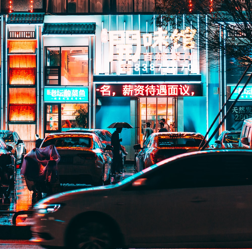 cars parked in front of store during night time