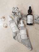 A serene flat lay of skincare products on a marble surface.