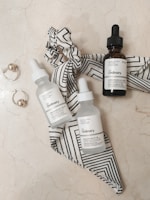 A beautifully arranged flat lay of skincare products on a marble surface.