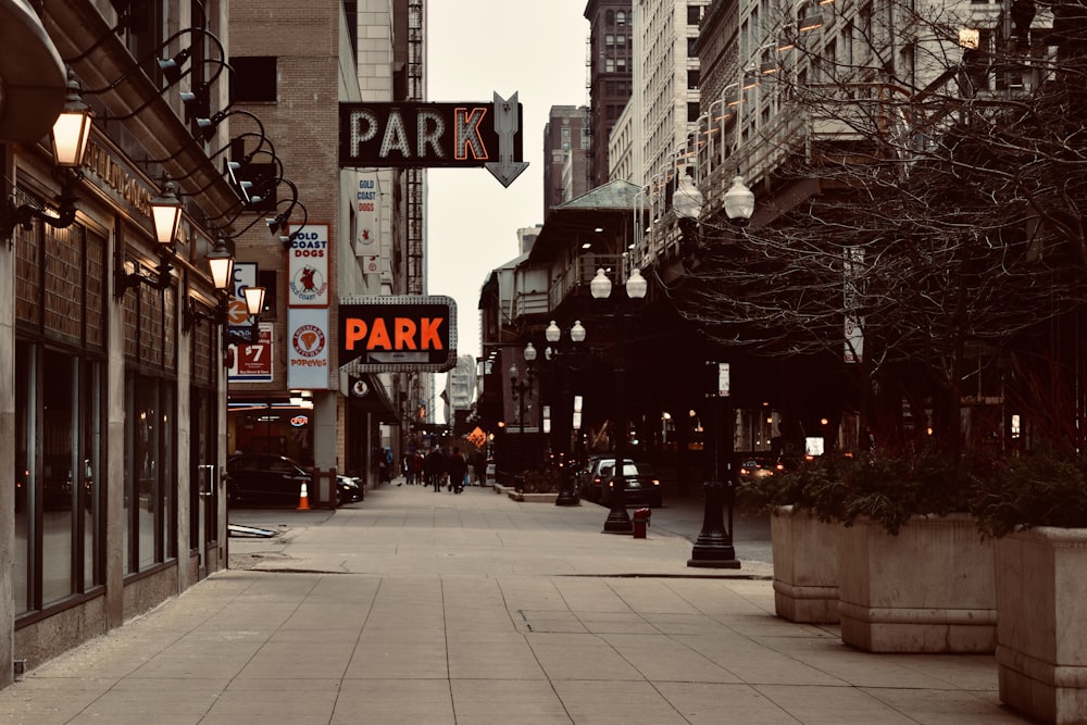 people walking on sidewalk near buildings during daytime