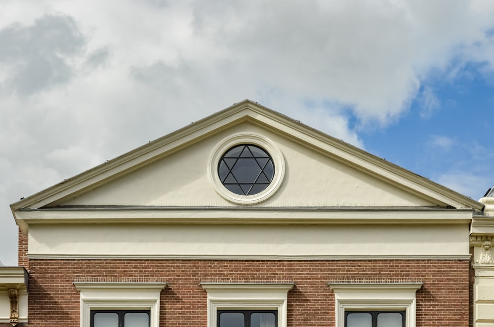 yellow and white concrete building under white clouds and blue sky during daytime