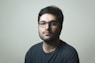 man in black crew neck shirt wearing black framed eyeglasses