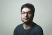man in black crew neck shirt wearing black framed eyeglasses