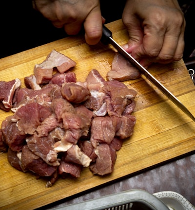 sliced meat on brown wooden chopping board