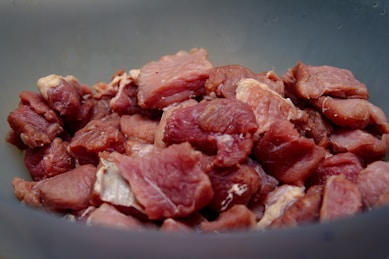 raw meat on blue ceramic bowl