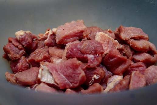 raw meat on blue ceramic bowl