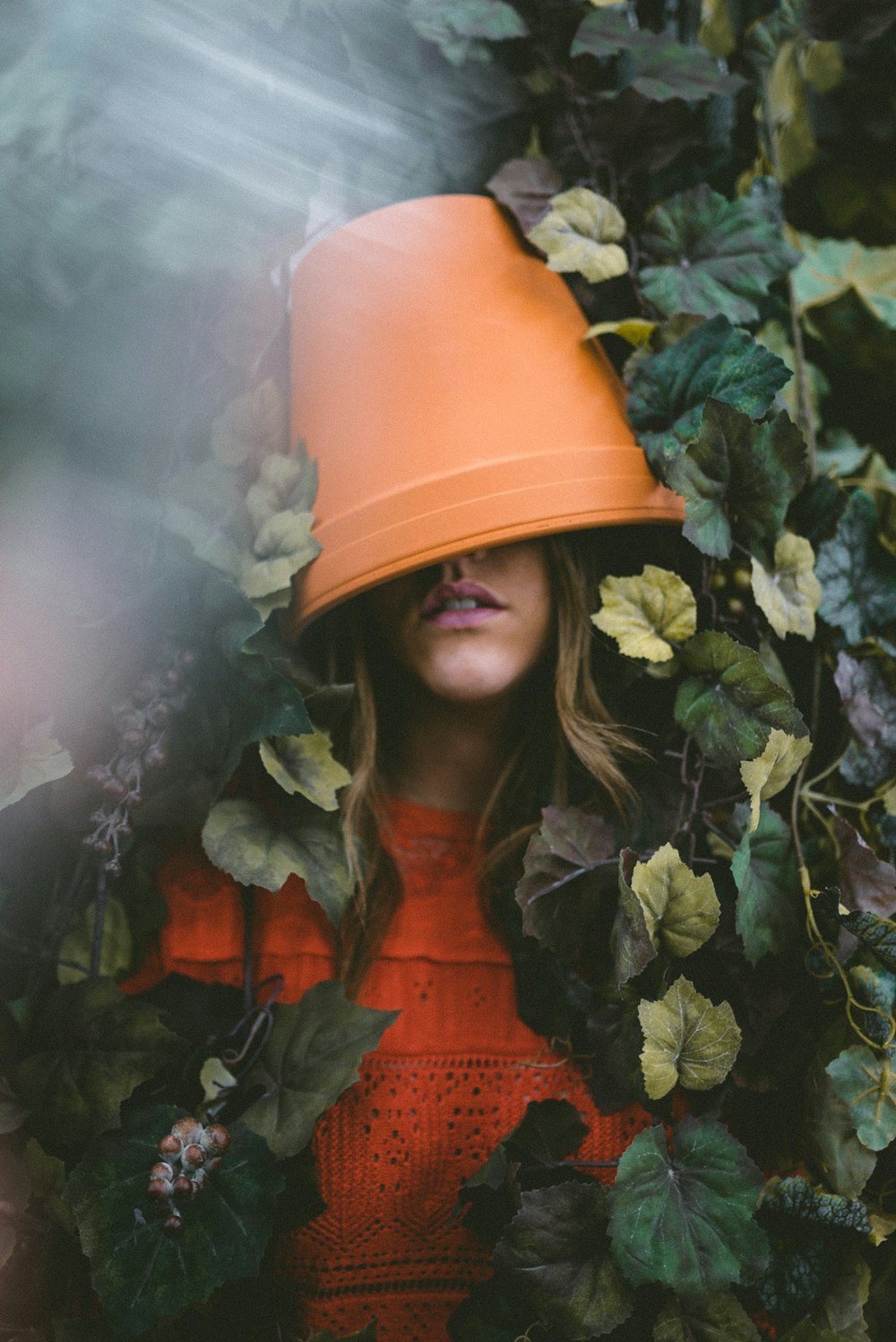 woman in black jacket standing beside green plant