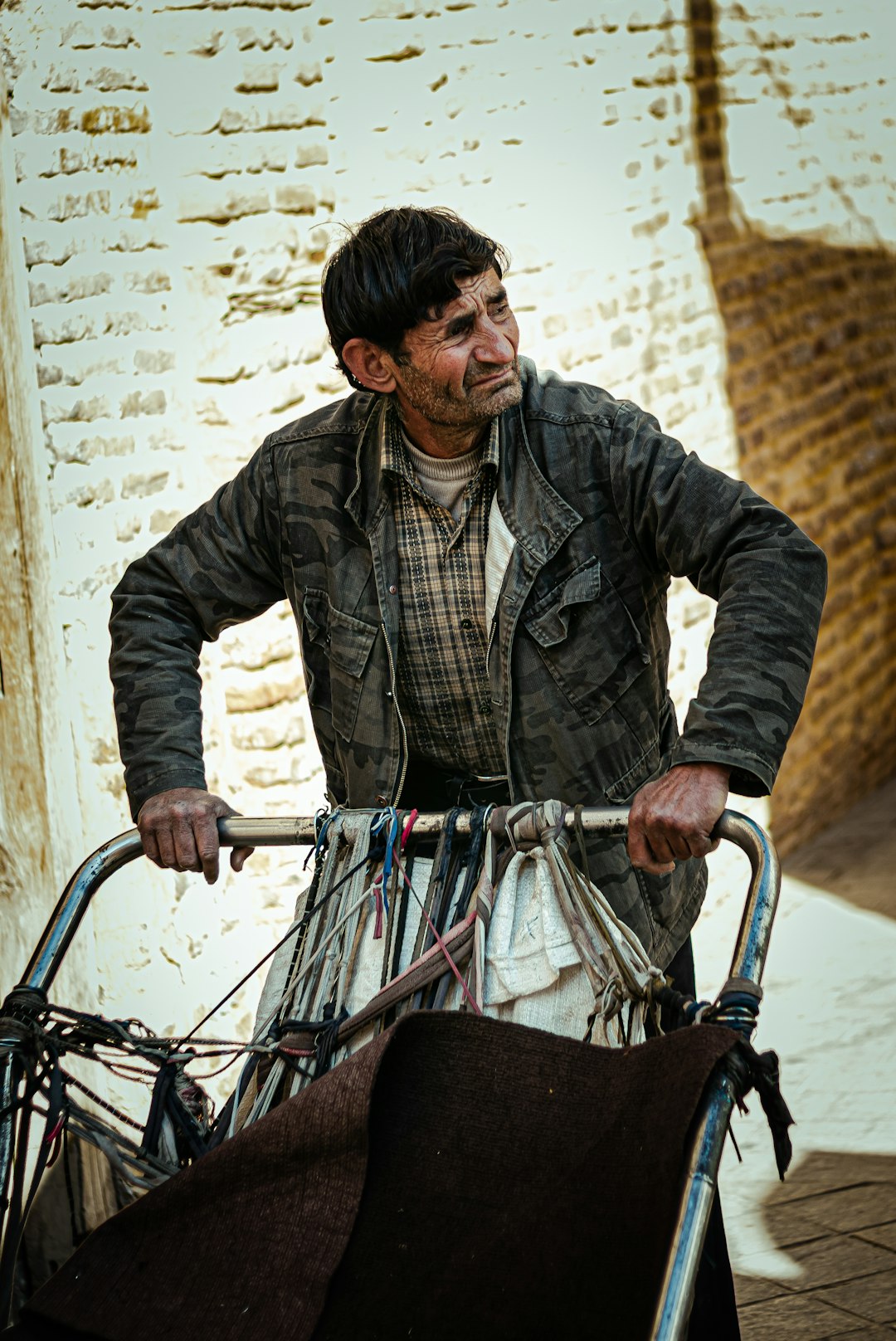 man in gray and black plaid dress shirt riding on black bicycle