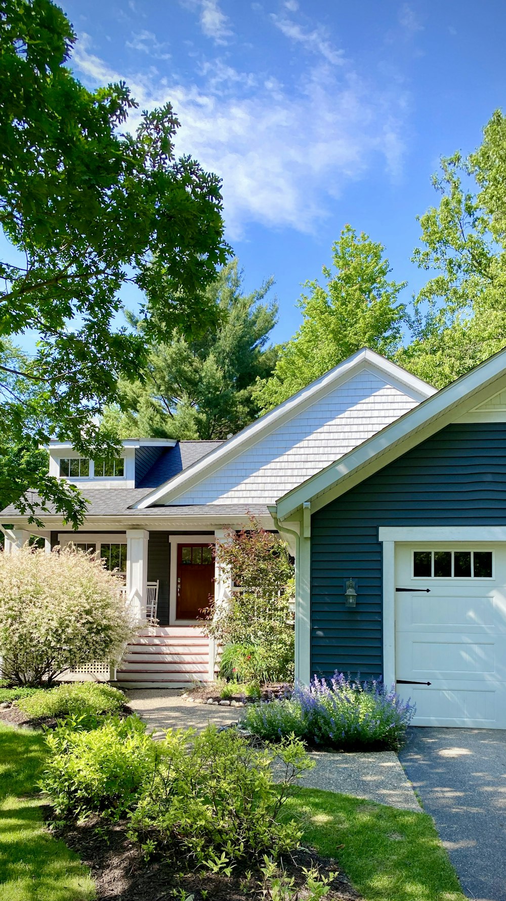 white and blue wooden house near green trees during daytime