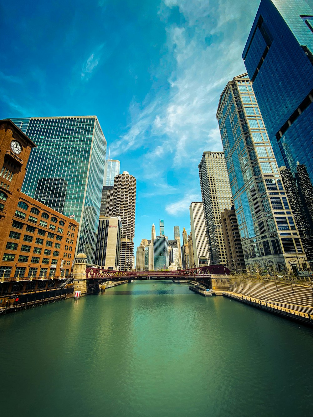 high rise buildings near body of water under blue sky during daytime