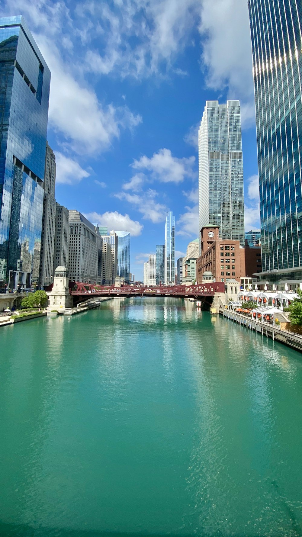 body of water between high rise buildings during daytime