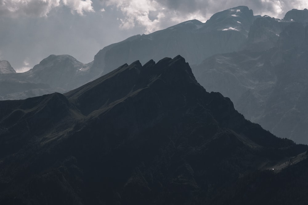 black and white mountains under white clouds