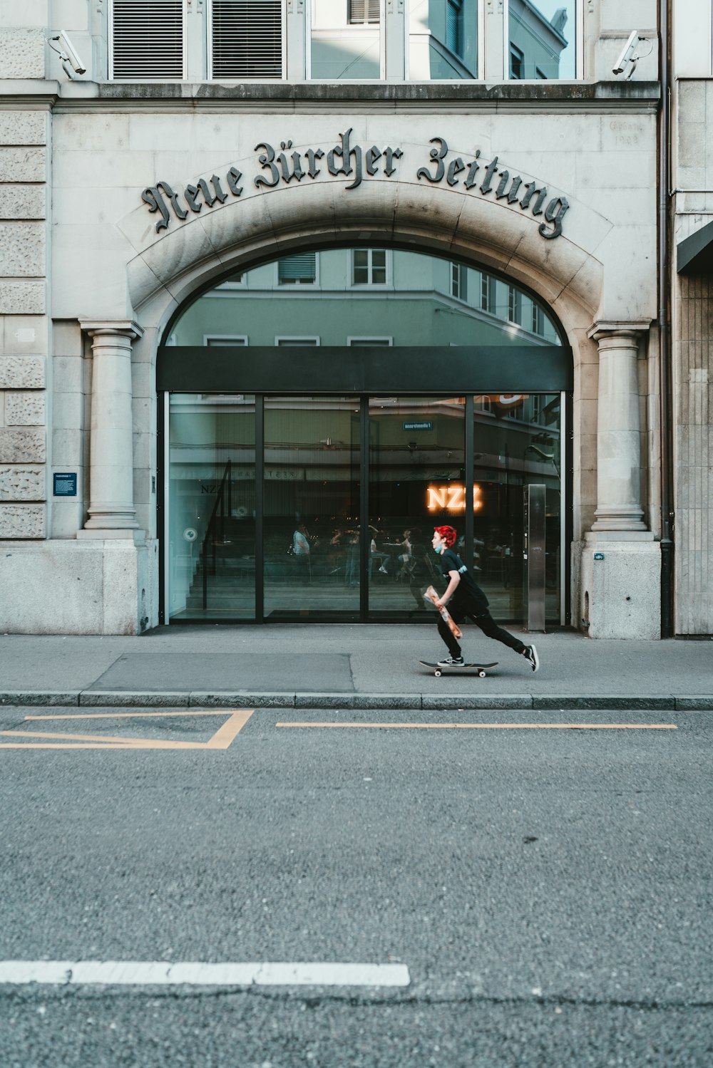 man in black jacket and black pants walking on sidewalk during daytime