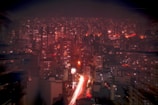 A bustling cityscape illuminated at night.