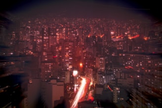 A bustling cityscape at night filled with lights.