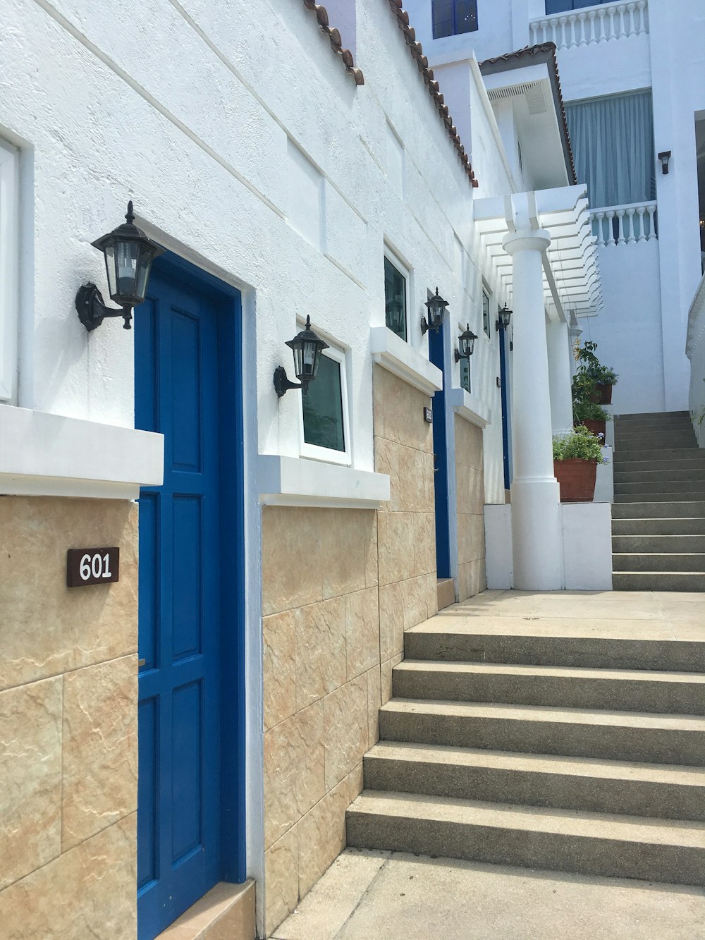 blue wooden door on white concrete building