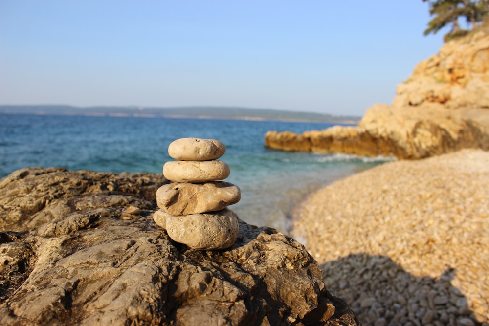 stack of stones on seashore during daytime