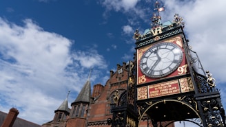 brown and white clock tower under blue sky during daytime