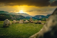 Stonehenge-like circle of weathered stones under a twilight sky with faint golden hues.