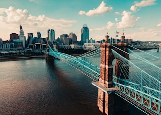 bridge over water near city buildings during daytime