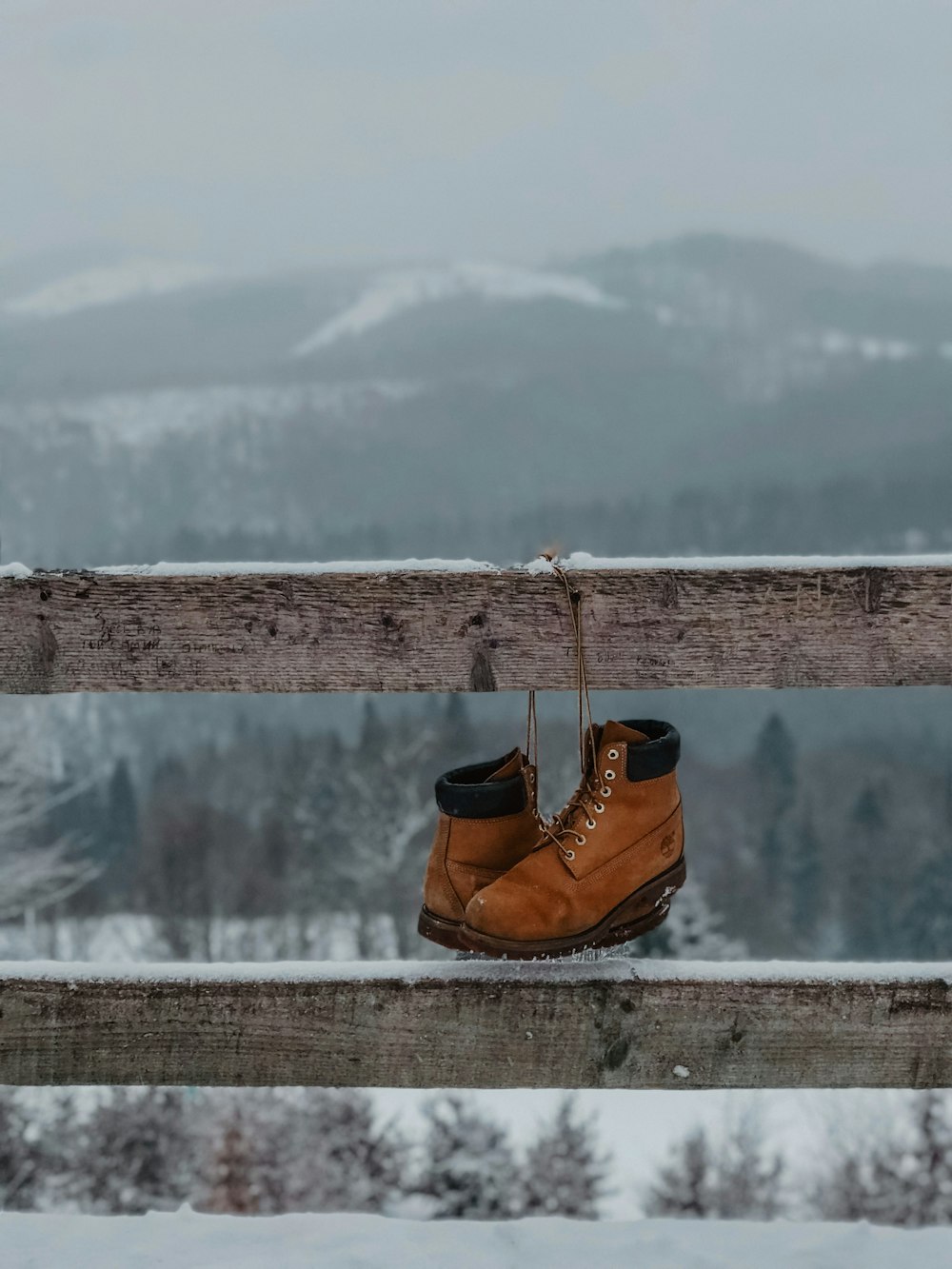 brown leather hiking backpack on brown wooden fence during daytime