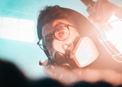 woman in black goggles and gas mask concerned zoom background