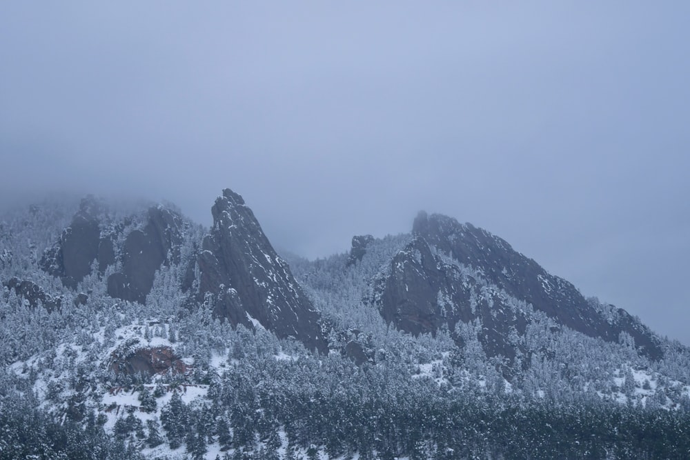 snow covered mountain under white sky during daytime