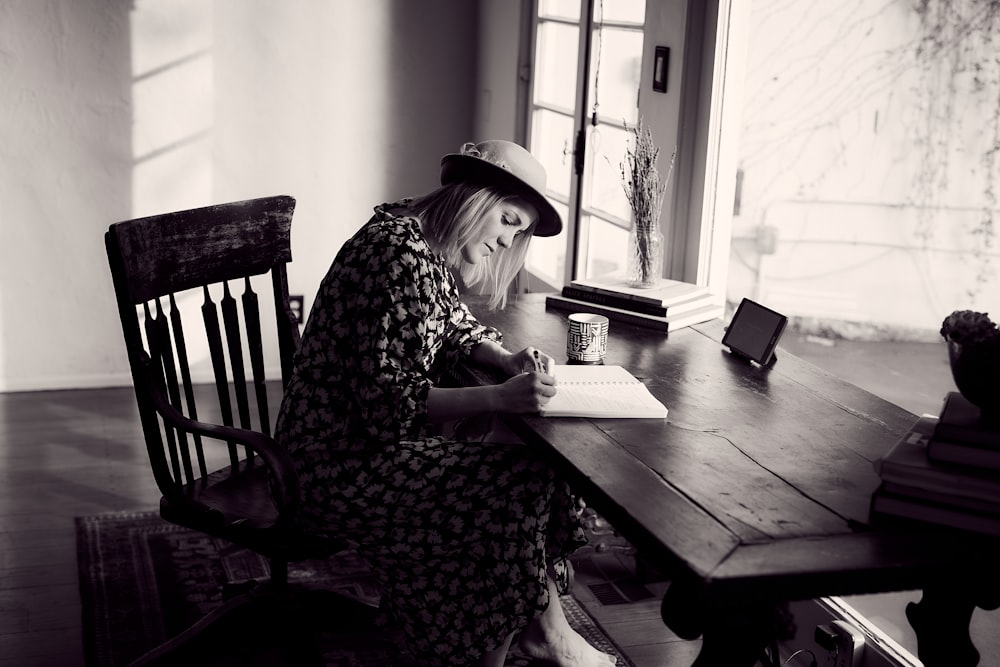 woman in black and white floral dress sitting on chair