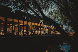 Elegant nighttime view of the lake with softly lit tables and golden accents.