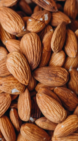 An overhead view of almond slivers arranged artistically on a cream-colored cloth emphasizing the farm’s premium quality.