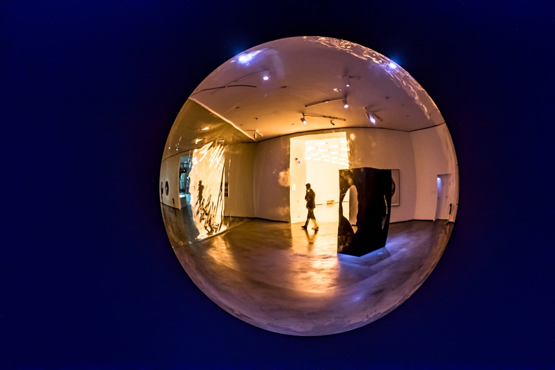 clear glass ball with reflection of man standing on the floor